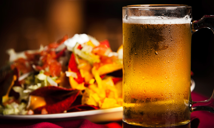 Photo of a sandwich and glass of beer.